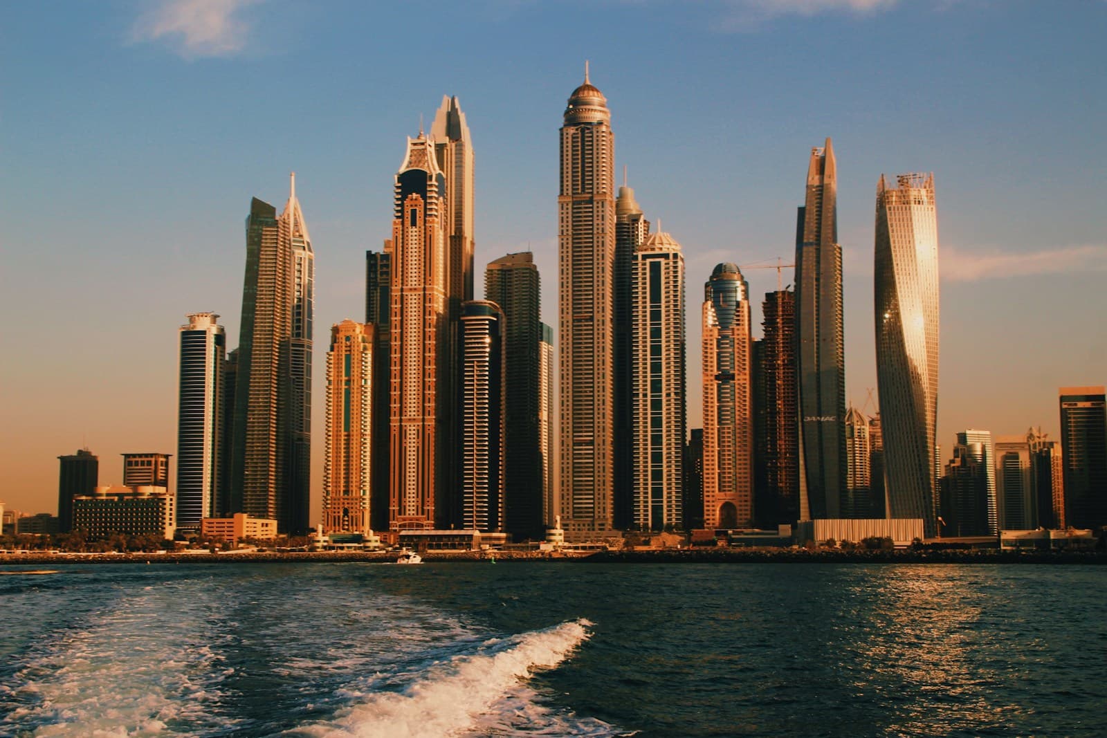 A view of Dubai's business district with modern skyscrapers at dusk.